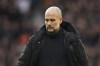 Manchester City's head coach Pep Guardiola walks on the pitch after the English Premier League soccer match between Manchester United and Manchester City at Old Trafford in Manchester, England, Saturday, Jan. 14, 2023. (AP Photo/Dave Thompson)
