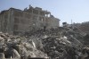 A man walks among the debris of collapsed buildings in Hatay, southern Turkey, Thursday, Feb. 9, 2023. Emergency crews made a series of dramatic rescues in Turkey on Friday, pulling several people, some almost unscathed, from the rubble, four days after a catastrophic earthquake killed more than 20,000. (AP Photo/Can Ozer)