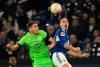 Schalke's Michael Frey, right, and Wolfsburg's Micky van de Ven fight for the ball during the German Bundesliga soccer match between FC Schalke and VfL Wolfsburg at the Veltins Arena in Gelsenkirchen, Germany, Friday, Feb. 10, 2023. (Bernd Thissen/dpa via AP)