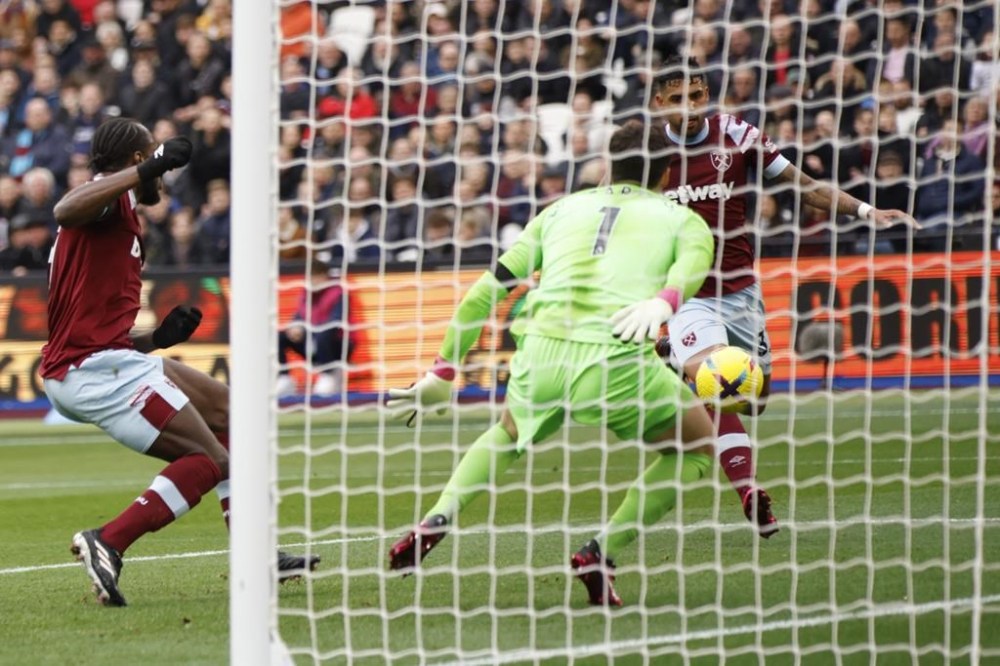 West Ham's Emerson Palmieri, right, scores his side's opening goal during the English Premier League soccer match between West Ham United and Chelsea in London, Saturday, Feb. 11, 2023. (AP Photo/David Cliff)