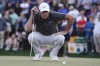 Scottie Scheffler reads a putt on the 18th hole during the third round of the Phoenix Open golf tournament, Saturday, Feb. 11, 2023, in Scottsdale, Ariz. Scheffler leads the tournament at 13 under par. (AP Photo/Darryl Webb)