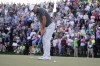 Scottie Scheffler putts on the 18th hole during the third round of the Phoenix Open golf tournament, Saturday, Feb. 11, 2023, in Scottsdale, Ariz. Scheffler leads the tournament at 13 under par. (AP Photo/Darryl Webb)