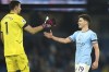 Manchester City's Julian Alvarez, right, greets Aston Villa's goalkeeper Emiliano Martinez after the English Premier League soccer match between Manchester City and Aston Villa at the Etihad Stadium in Manchester, England, Sunday, Feb. 12, 2023. (AP Photo/Dave Thompson)