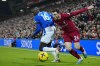 Everton's Abdoulaye Doucoure, left, is challenged by Liverpool's Andrew Robertson during the English Premier League soccer match between Liverpool and Everton at the Anfield stadium in Liverpool, England, Monday, Feb. 13, 2023. (AP Photo/Jon Super)