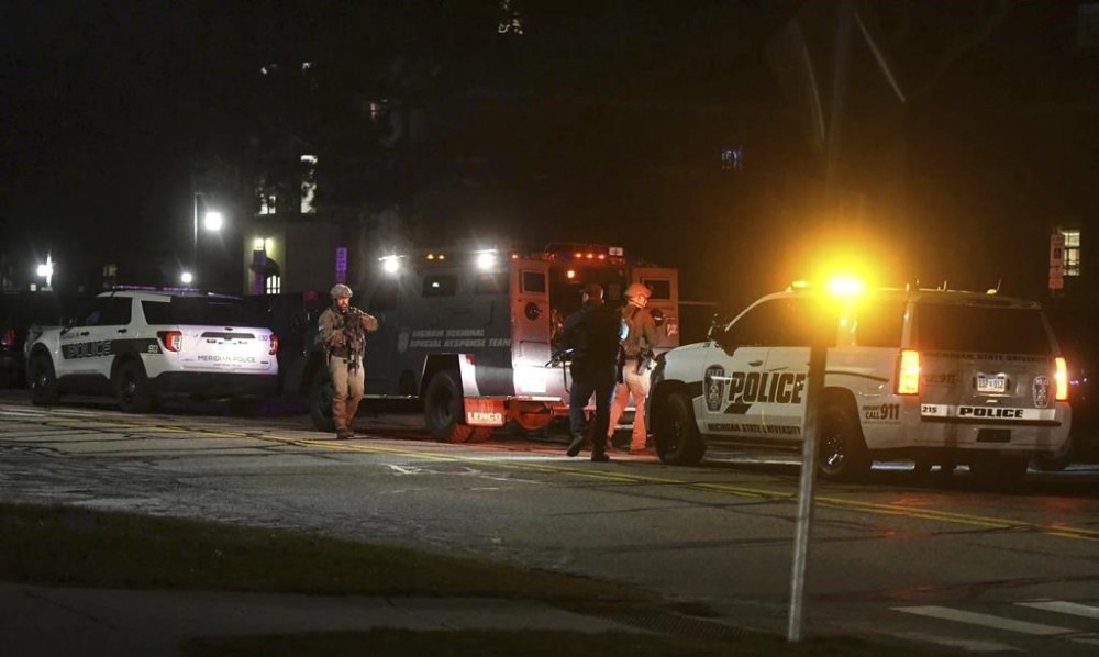 First responders prepare to sweep Snyder Hall on the campus of Michigan State University in East Lansing, Mich., Monday, Feb. 13, 2023. Police urged frightened students and others to shelter in place as they searched for a gunman who opened fire Monday night at the university. (Matthew Dae Smith/Lansing State Journal via AP)