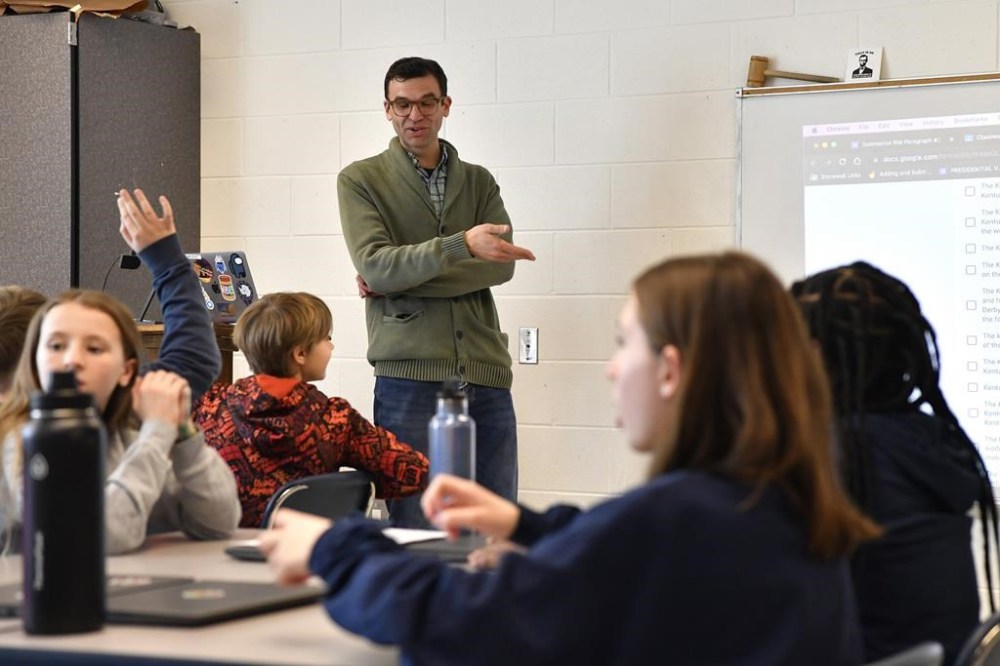 Teacher Donnie Piercey goes over the results of a writing assignment called