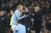 Manchester City's Erling Haaland talks with Manchester City's head coach Pep Guardiola during the English Premier League soccer match between Manchester City and Aston Villa at the Etihad Stadium in Manchester, England, Sunday, Feb. 12, 2023. (AP Photo/Dave Thompson)