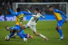 Real Madrid's Dani Ceballos, center, vies for the ball with Valencia defenders during the Spanish La Liga soccer match between Real Madrid and Valencia at Santiago Bernabeu stadium in Madrid, Thursday, Feb. 2, 2023. (AP Photo/Bernat Armangue)