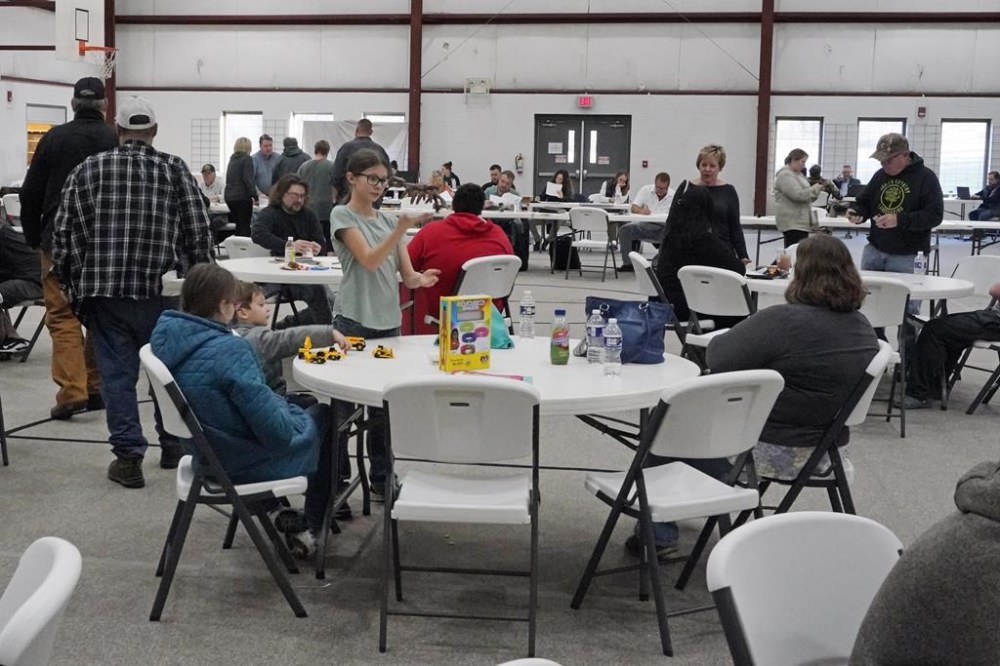 People gather at the Norfolk Southern Railways Assistance Center Thursday, Feb. 9, 2013, at the Abundant Life Fellowship in East Palestine, Ohio. Cleanup continues of a Norfolk Southern freight train derailment that derailed Friday night in East Palestine, Ohio. (AP Photo/Gene J. Puskar)