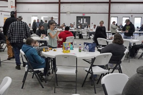 People gather at the Norfolk Southern Railways Assistance Center Thursday, Feb. 9, 2013, at the Abundant Life Fellowship in East Palestine, Ohio. Cleanup continues of a Norfolk Southern freight train derailment that derailed Friday night in East Palestine, Ohio. (AP Photo/Gene J. Puskar)