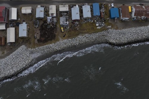 FILE - Small waves crash into reinforced seawalls in Shishmaref, Alaska, Tuesday, Oct. 4, 2022. Rising sea levels, flooding, increased erosion and loss of protective sea ice and land have led residents of this island community to vote twice to relocate. U.N. Secretary-General Antonio Guterres warned Tuesday, Feb. 14, 2023, that even if global warming is 