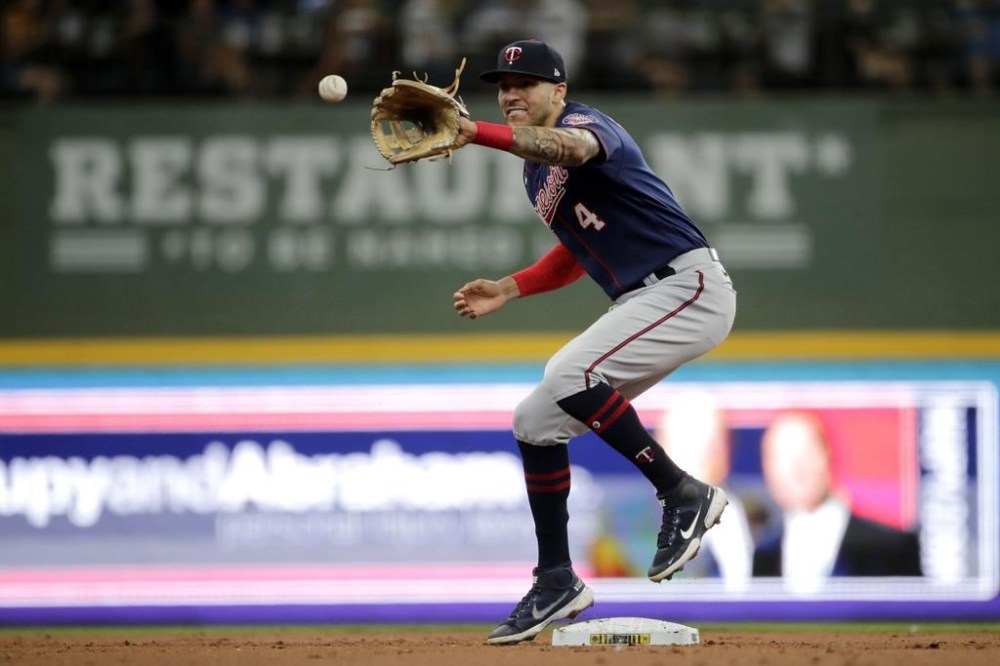 FILE - Minnesota Twins' Carlos Correa catches a ball as he tags second base to start a double play during the first inning of a baseball game against the Milwaukee Brewers on July 27, 2022, in Milwaukee. Minnesota's signing of Carlos Correa last month altered the path for top Twins prospects Royce Lewis and Brooks Lee, with Correa cementing their natural position of shortstop for at least the next six years. (AP Photo/Aaron Gash, File)
