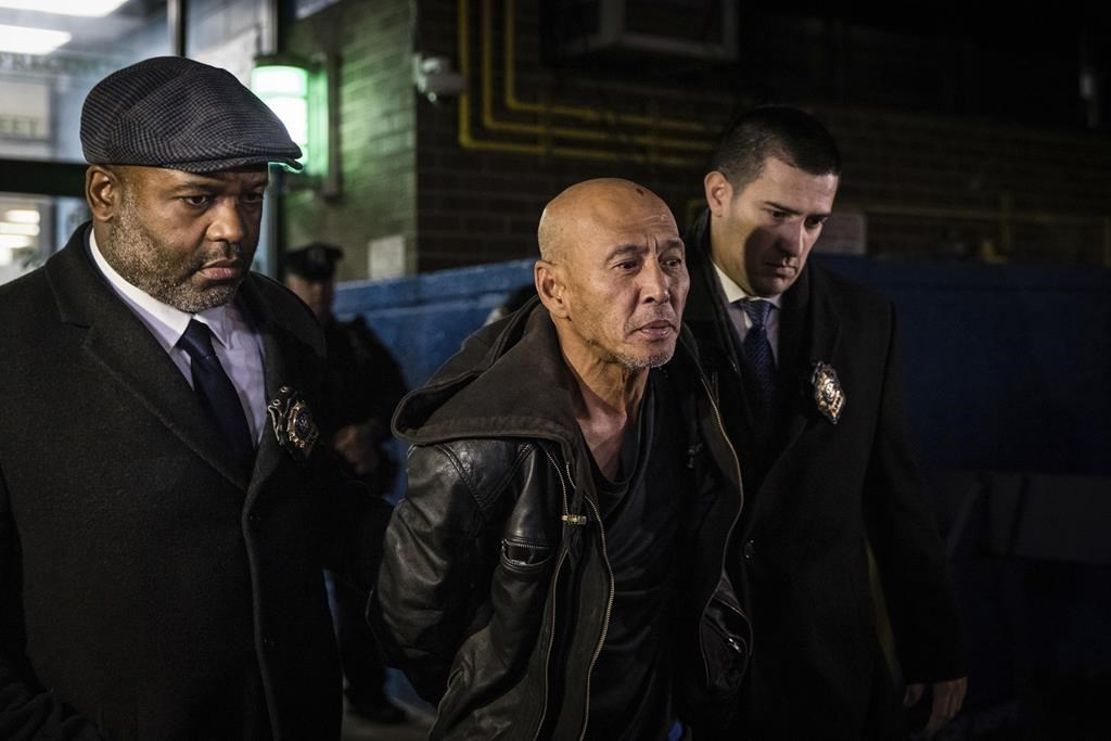 Weng Sor is walked by New York Police Department detectives out of the 68th Precinct in the Brooklyn borough of New York, Tuesday, Feb. 14, 2023. Sor, who went on a deadly rampage with a U-Haul truck the day before in New York City, was suffering from an apparent mental health crisis and said he started mowing people down after seeing an “invisible object” coming toward him, police said. (AP Photo/Stefan Jeremiah)