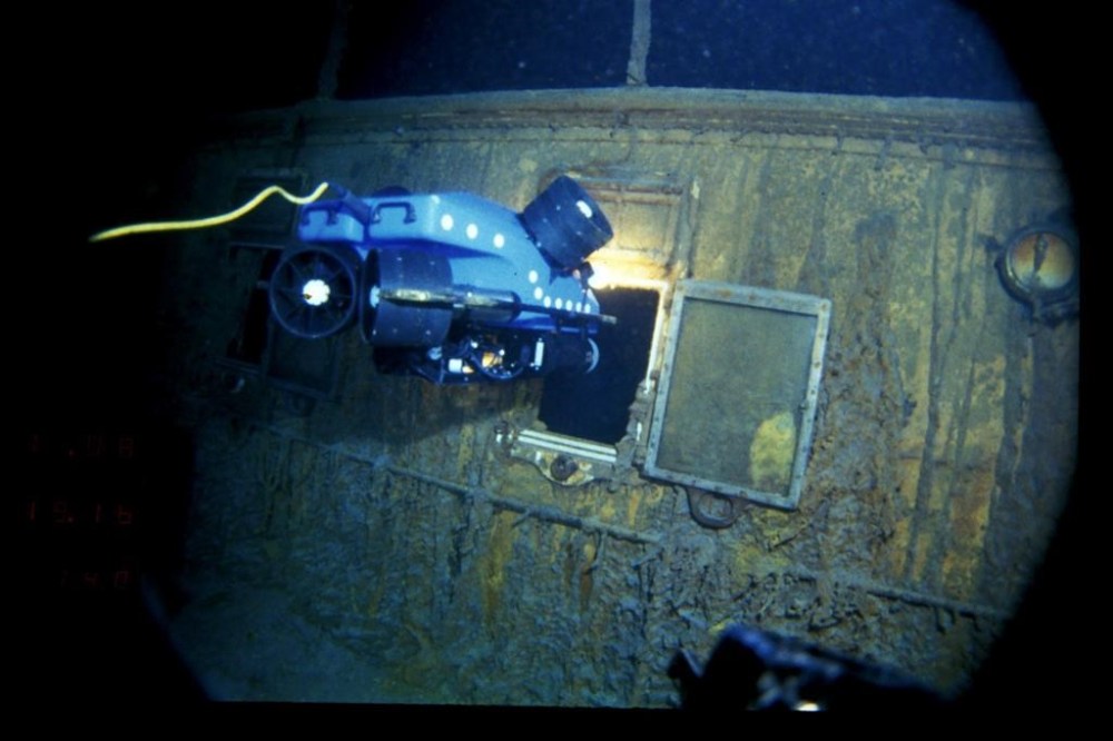 In this image provided by the Woods Hole Oceanographic Institution, an underwater remote vehicle examines an open window of the Titanic 12,500 feet (3.8 kilometers) below the surface of the ocean, 400 miles (640 kilometers) off the coast of Newfoundland, Canada in 1986. Rare and in some cases never before publicly seen video of the dive is being released on Wednesday, Feb. 15, 2023, by the Woods Hole Oceanographic Institution. (Woods Hole Oceanographic Institution via AP)