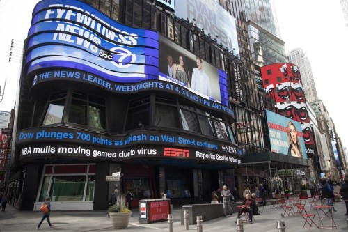 FILE - An electronic ticker displays news Wednesday, March 11, 2020, in New York's Times Square. A new survey released Wednesday, Feb. 15, 2023, shows fully half of Americans indicate they believe national news organizations intend to mislead, misinform or persuade the public to adopt a point of view. (AP Photo/Mary Altaffer, File)