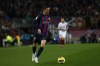 Barcelona's Robert Lewandowski runs with the ball during a Spanish La Liga soccer match between Barcelona and Sevilla at the Camp Nou stadium in Barcelona, Spain, Sunday, Feb. 5, 2023. (AP Photo/Joan Monfort)