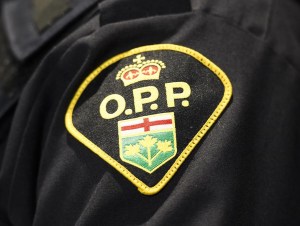 An Ontario Provincial Police logo is shown during a press conference in Barrie, Ont., on April 3, 2019. THE CANADIAN PRESS/Nathan Denette