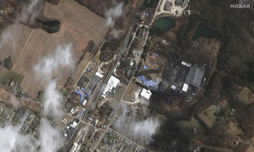 This satellite image provided by Maxar Technologies shows an overview of the aftermath of the Norfolk Southern train derailment on Wednesday, Feb. 15, 2023, in East Palestine, Ohio. About 50 cars derailed in a fiery, mangled mess on the outskirts of East Palestine on Feb. 3. (Satellite image ©2023 Maxar Technologies via AP)