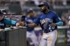 FILE -Seattle Mariners' Taylor Trammell (20) celebrates after scoring against the Oakland Athletics during the seventh inning of a baseball game in Oakland, Calif., Tuesday, June 21, 2022. Seattle Mariners outfielder Taylor Trammell will have surgery on his broken right hand and is expected to need six to seven weeks to recover, Wednesday, Feb. 15, 2023. (AP Photo/John Hefti, File)