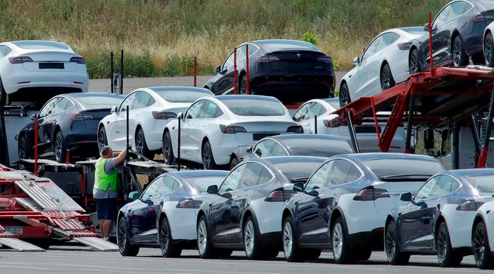 FILE - Tesla cars are loaded onto carriers at the Tesla electric car plant on May 13, 2020, in Fremont, Calif. Tesla is recalling nearly 363,000 vehicles with its “Full Self-Driving” system to fix problems with the way it behaves around intersections and following posted speed limits, the National Highway Traffic Safety Administration announced Thursday, Feb. 16, 2023. (AP Photo/Ben Margot, File)