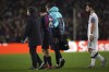 Barcelona's Pedri leaves the pitch after he was injured during the Europa League playoff first leg soccer match between Barcelona and Manchester United at the Camp Nou stadium in Barcelona, Spain, Thursday, Feb. 16, 2023. (AP Photo/Joan Mateu Parra)