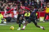 Brentford's Josh Dasilva, left, and Crystal Palace's Albert Sambi Lokonga battle for the ball during the English Premier League soccer match at the Gtech Community Stadium, London, Saturday, Feb. 18, 2023. (Ben Whitley/PA via AP)