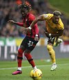 Bournemouth's Jordan Zemura, left, and Wolverhampton Wanderers' Adama Traore battle for the ball during the Premier League match between Wolverhampton Wanderers and AFC Bournemouth at Molineux Stadium in Wolverhampton, England, Saturday Feb. 18, 2023. (Mike Egerton/PA via AP)