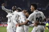 Real Madrid's Marco Asensio, centre, celebrates with teammates after scoring his side's second goal during the Spanish La Liga soccer match between Osasuna and Real Madrid at El Sadar stadium in Pamplona, Spain, Saturday, Feb. 18, 2023. (AP Photo/Alvaro Barrientos)