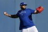 Toronto Blue Jays starting pitcher Alek Manoah, right, warms up during baseball spring training in Dunedin, Fla., on Thursday, February 16, 2023. THE CANADIAN PRESS/Nathan Denette