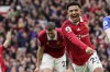 Manchester United's Jadon Sancho celebrates after scoring his side's third goal during the English Premier League soccer match between Manchester United and Leicester City at the Stamford Bridge stadium in Manchester, England, Sunday, Feb. 19, 2023. (AP Photo/Dave Thompson)