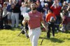 Jon Rahm tips his hat to the gallery on the 18th green after winning the Genesis Invitational golf tournament at Riviera Country Club, Sunday, Feb. 19, 2023, in the Pacific Palisades area of Los Angeles. (AP Photo/Ryan Kang)