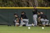 Pittsburgh Pirates players react as a guest gets medical attention during spring training baseball camp in Bradenton, Fla., Tuesday, Feb. 21, 2023. “He was attended to by Pirates medical personnel, is alert and responsive, and being transported to a local hospital for further evaluation,” the Pirates said in a statement. (Ben B. Braun/Pittsburgh Post-Gazette via AP)