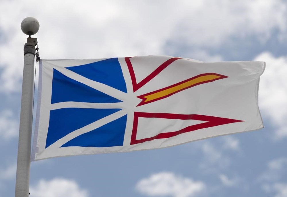 Newfoundland and Labrador's provincial flag flies on a flag pole in Ottawa, Friday July 3, 2020. An unvaccinated town councillor in rural Newfoundland has his job back after a provincial Supreme Court judge ruled he was unjustly removed for not attending meetings in person. THE CANADIAN PRESS/Adrian Wyld