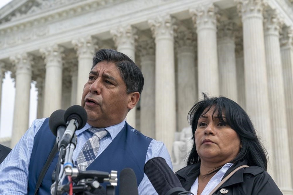 Beatriz Gonzalez, right, the mother of 23-year-old Nohemi Gonzalez, a student killed in the Paris terrorist attacks, and stepfather Jose Hernandez, speak outside the Supreme Court,Tuesday, Feb. 21, 2023, in Washington. A lawsuit against YouTube from the family of Nohemi Gonzalez was argued at the Supreme Court. (AP Photo/Alex Brandon)