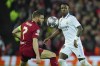 Real Madrid's Vinicius Junior, right, passes the ball past Liverpool's James Milner during the Champions League, round of 16, first leg soccer match between Liverpool and Real Madrid at the Anfield stadium in Liverpool, England, Tuesday, Feb. 21, 2023. (AP Photo/Jon Super)