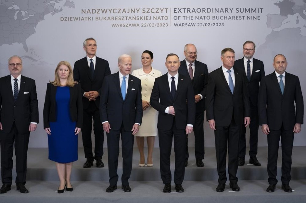 President Joe Biden participates in a family photo during a meeting with the leaders of the Bucharest Nine, a group of nine countries that make up the eastern flank of NATO, Wednesday, Feb. 22, 2023, in Warsaw. From left are Latvian President Egils Levits, Slovakia President Suzana Caputova, NATO Secretary General Jens Stoltenberg, Biden, Hungarian President Katalin Novák, Polish President Andrzej Duda, Estonia President Alar Karis, Romania President Klaus Werner Iohannis, Czech Republic Prime Minister Petr Fiala, Bulgaria President Ruman Radev and Lithuania President Gitanas Nauseda. (AP Photo/ Evan Vucci)