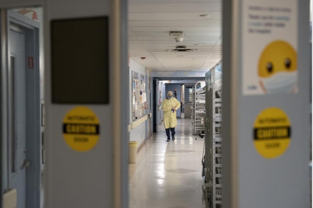A health-care worker is seen at Toronto’s Hospital for Sick Children, on Wednesday, Nov. 30, 2022. Ontario's hospitals say they are optimistic the province's new health-care reform legislation will protect a drain of workers to the expansion of private surgical clinics. THE CANADIAN PRESS/Chris Young