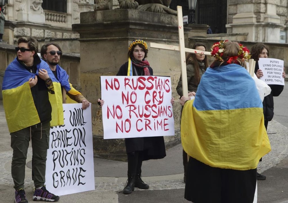 Demonstrators protest in front of Hofburg Palace during an OSCE Parliamentary Assembly, in Vienna, Austria, Thursday, Feb. 23, 2023. A meeting of the Organization for Security and Cooperation in Europe’s parliamentary assembly has got under way, with Ukraine’s delegation boycotting the event. The two-day meeting of the normally low-profile assembly, which coincides with the anniversary of Russia’s invasion of Ukraine, has been overshadowed by controversy over the Russians’ attendance. (AP Photo/Heinz-Peter Bader)