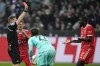 Referee Tobias Welz, left, shows a red card to Bayern's Dayot Upamecano, right, during the German Bundesliga soccer match between Borussia Moenchengladbach and Bayern Munich at the Borussia Park in Moenchengladbach, Germany, Saturday, Feb. 18, 2023. (AP Photo/Martin Meissner)
