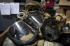 Used rebreather masks rest in a pile as volunteers with Razom for Ukraine, a New York-based nonprofit, pack firefighting and medical donations for shipment to Ukraine, Wednesday, Feb. 8, 2023, in Woodbridge Township, N.J. (AP Photo/John Minchillo)