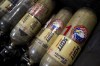 Volunteers with Razom for Ukraine, a New York-based nonprofit, pack firefighting and medical donations, including used oxygen canisters, for shipment to Ukraine, Wednesday, Feb. 8, 2023, in Woodbridge Township, N.J. (AP Photo/John Minchillo)