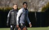 Vancouver Whitecaps FC's Sergio Cordova, right, runs past head coach Vanni Sartini during the team's practice in Vancouver, B.C., Tuesday, February 21, 2023.THE CANADIAN PRESS/Rich Lam