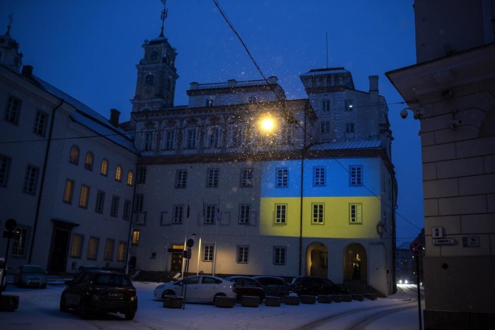 The Vilnius University building is illuminated with the colors of Ukraine to mark the one-year anniversary of Russia's invasion of the country, in Vilnius, Lithuania, Friday, Feb. 24, 2023. (AP Photo/Mindaugas Kulbis)