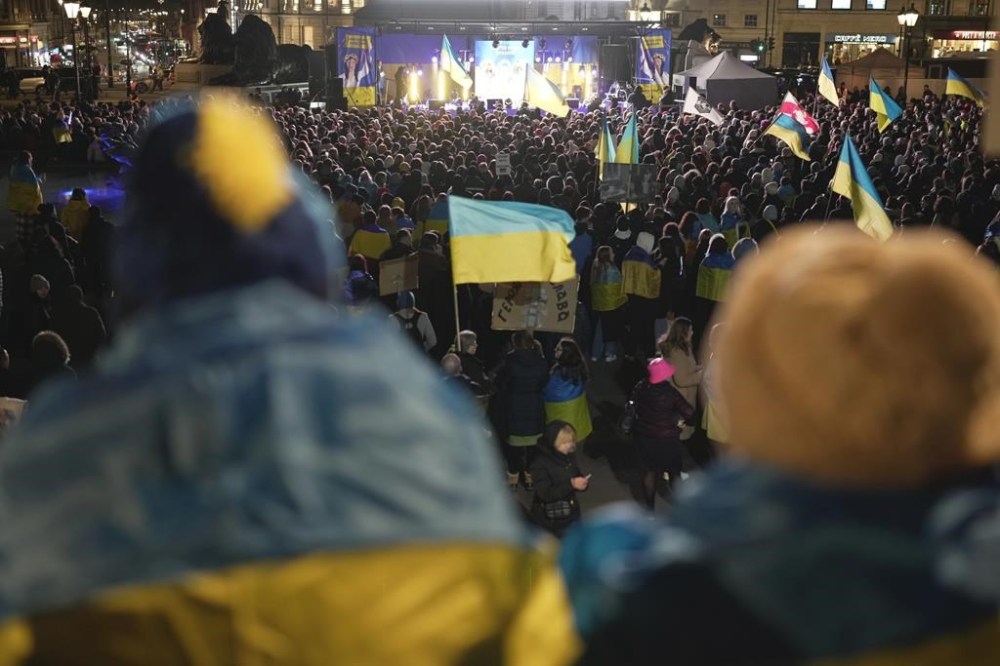 People attend a vigil at the Trafalgar Square organised by the Ukrainian and US Embassy, ahead of the one-year anniversary of the invasion of Ukraine, in London, Thursday, Feb. 23, 2023. (AP Photo/Kin Cheung)