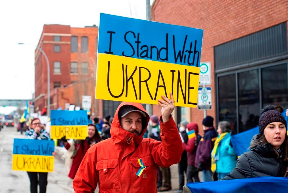 People take part in a rally in support of the Ukraine and against the Russian invasion, in Edmonton on Sunday February 27, 2022. From coast to coast, thousands of Canadians are expected to take part today in a series of rallies in support of Ukraine on the one-year anniversary of Russia's invasion. THE CANADIAN PRESS/Jason Franson