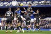 Everton's James Tarkowski, second left, heads the ball during the English Premier League soccer match between Everton and Aston Villa at Goodison Park, Liverpool, England, Saturday Feb. 25, 2023. (Peter Byrne/PA via AP)