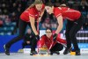 Team Canada skip Kerri Einarson delivers a rock as lead Briane Harris, left, and second Shannon Birchard, right, sweep while playing Nova Scotia in the playoffs at the Scotties Tournament of Hearts, in Kamloops, B.C., on Saturday, February 25, 2023. THE CANADIAN PRESS/Darryl Dyck