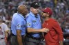FILE - St. Louis Cardinals manager Oliver Marmol, right, is restrained by umpire Jeff Nelson (45) while talking to C.B. Bucknor (54) during the third inning of the team's baseball game against the Arizona Diamondbacks on Aug. 21, 2022, in Phoenix. Marmol was ejected. Marmol said Bucknor “has zero class” for refusing to shake his hand during the lineup card exchange at home plate before a game against the Washington Nationals on Saturday, Feb. 25, 2023. Marmol was seeing Bucknor for the first time the Aug. 21 game. (AP Photo/Rick Scuteri, File)