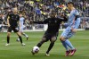 Nashville SC defender Shaq Moore (18) kicks the ball away from New York City FC defender Anton Tinnerholm (3) during the first half of an MLS soccer match, Saturday, Feb. 25, 2023, in Nashville, Tenn. (AP Photo/Mark Zaleski)