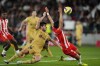 Barcelona's Sergi Roberto, left, vies for the ball with Almeria's Lucas Robertone during the Spanish La Liga soccer match between Almeria and Barcelona at the Juegos Mediterraneos stadium in Almeria, Spain, Sunday, Feb. 26, 2023. (AP Photo/Jose Breton)